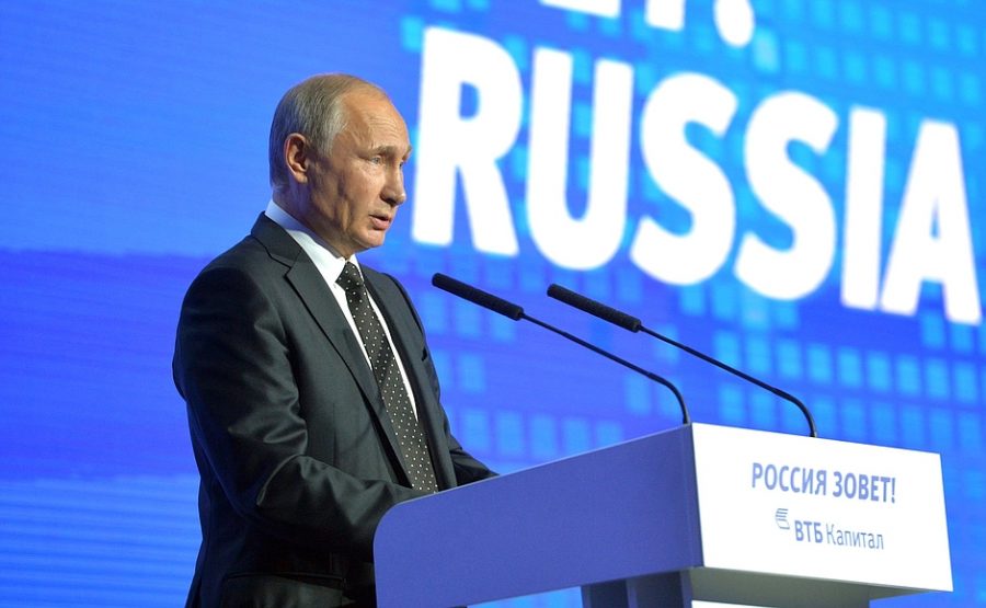 Russian president Vladimir Putin delivers a speech at a forum. 