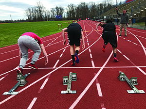 Neshaminy sprinters leap off the blocks during a practice race. 