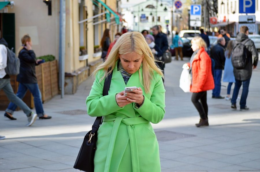 Many young adults simultaneously walk and text, never looking up from their phones.