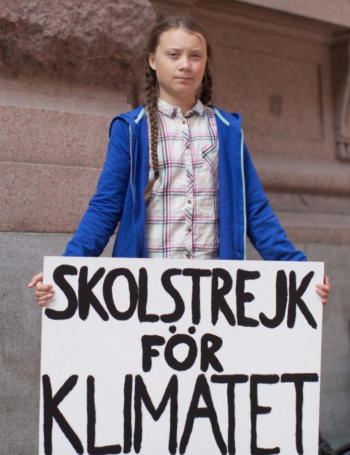 Greta Thunburg with her famous sign, which translates to School Strike for the Climate in Swedish