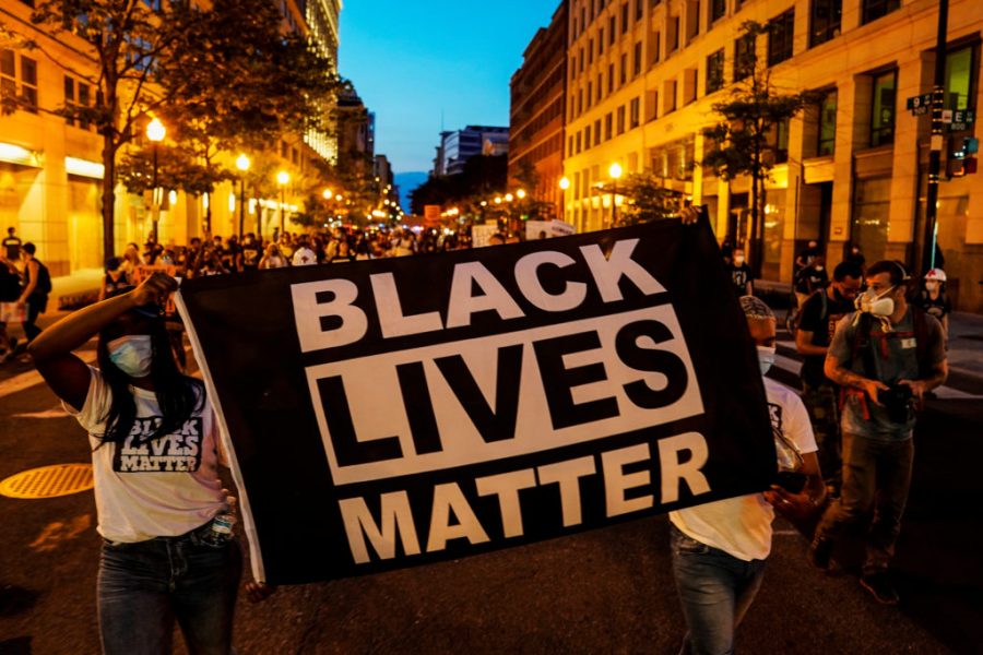 People+hold+up+a+Black+Lives+Matter+banner+as+they+march+during+a+demonstration+against+racial+inequality+in+the+aftermath+of+the+death+in+Minneapolis+police+custody+of+George+Floyd%2C+in+Washington%2C+U.S.%2C+June+14%2C+2020.+REUTERS%2FErin+Scott