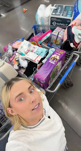 Screenshot of Serena Neel’s angel tree TikTok (@serenaneel) posted on Dec. 13. Neel is posing in front of carts full of donations to angel tree recipients. (TikTok/Serena Neel)