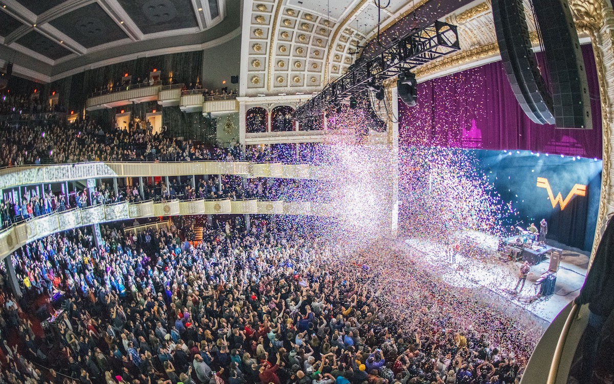 Weezer performing at the Met in 2018. After a successful show, they celebrate by shooting confetti out to the fans. (Technical.ly/A.D Amorosi)